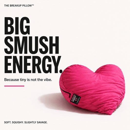 A bright pink heart-shaped pillow on a white background with bold black text reading 'BIG SMUSH ENERGY.' and smaller marketing copy.