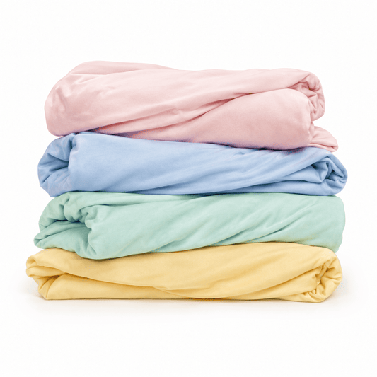 Stack of pastel folded Petty Pillowcases – customizable soft cooling bamboo covers for breakup pillows by The Breakup Pillow