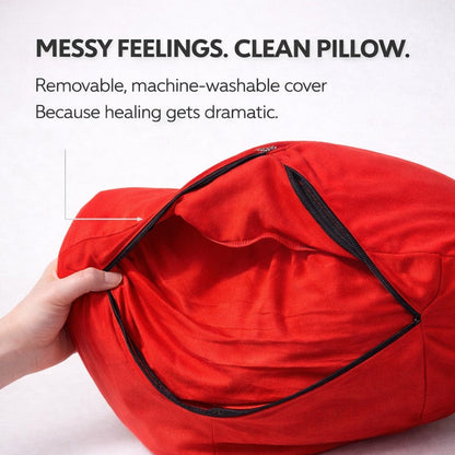 Red pillow with a hand opening it, text about machine-washable cover.