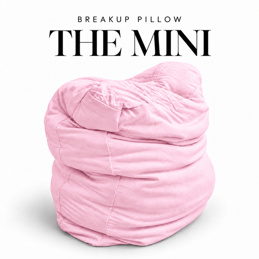 The Mini Breakup Pillow in baby pink – Post-Cry Pretty 16x16x3 small squishy cuddle pillow, folded and slouched