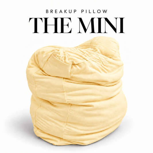 The Mini Breakup Pillow in butter yellow – Sunny But Still Mad 16x16x3 small squishy cuddle pillow, folded and slouched
