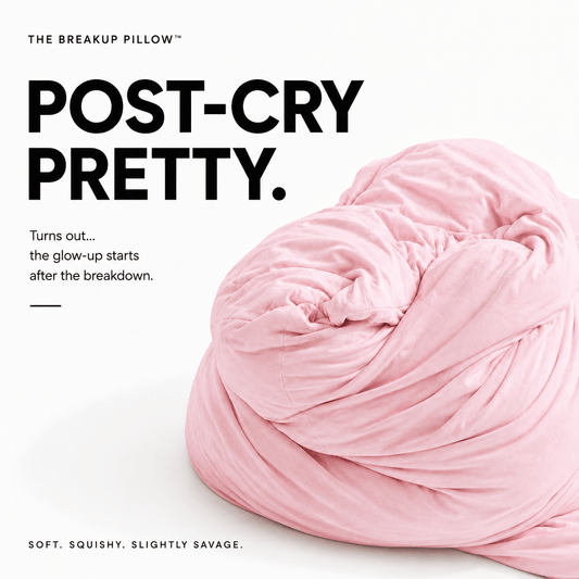 A pink plush throw pillow photographed on a clean white background with large black text reading 'POST-CRY PRETTY.' and smaller marketing copy about feeling glow-up after a breakdown.
