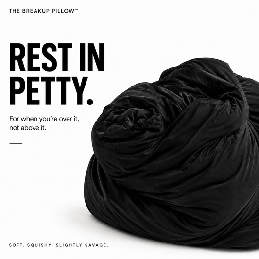 A black velvet-like breakup pillow, shown partially deflated and crumpled on a white background with bold text reading 'REST IN PETTY.' and smaller tagline text.