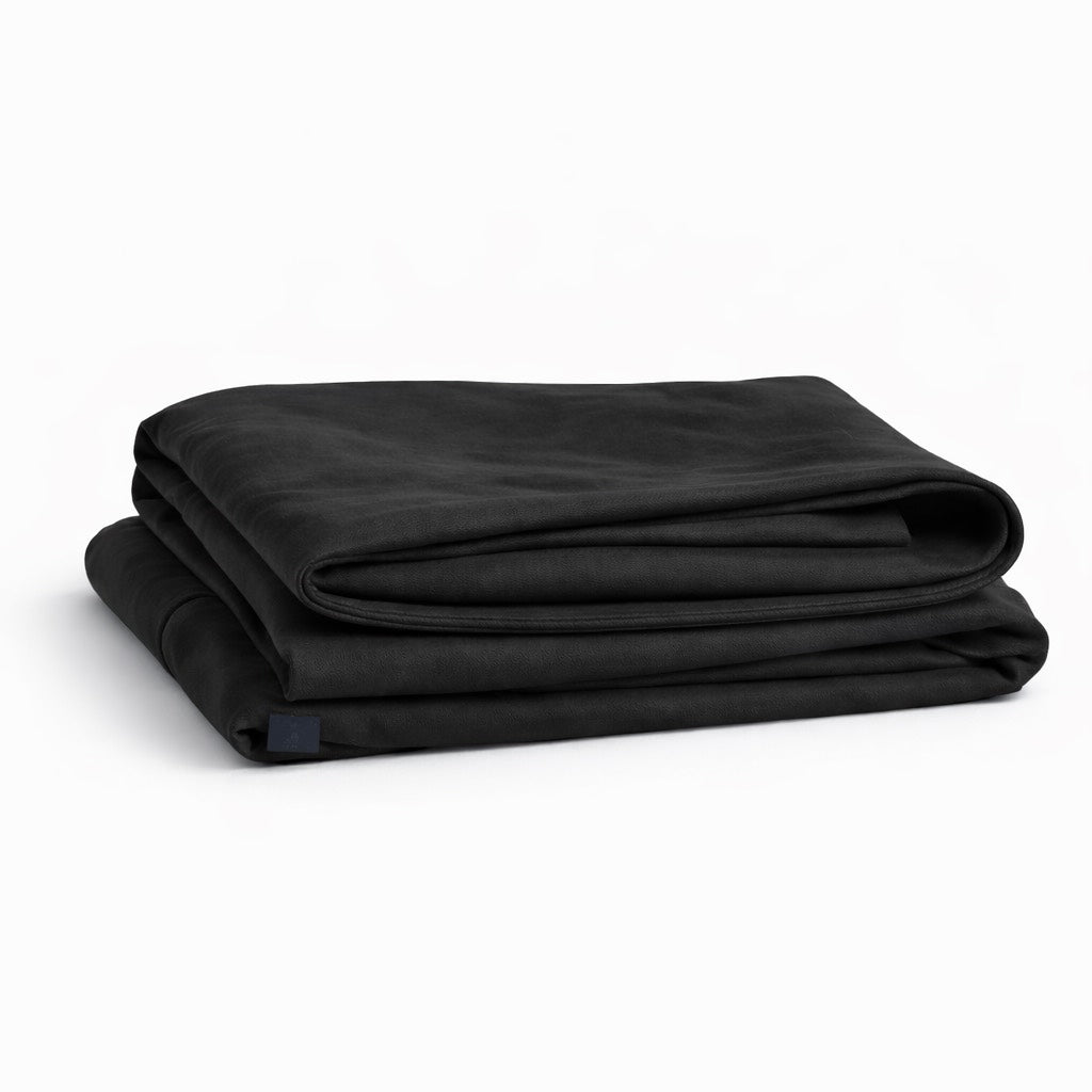 Folded black rest in petty pillowcase on a white background
