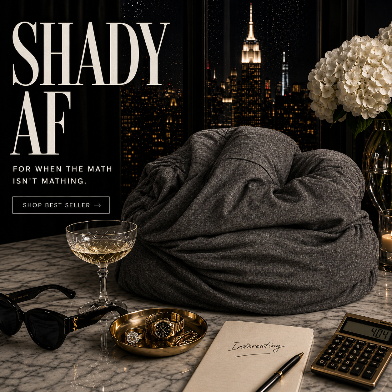Gray pillow on a marble surface with a luxury items, calculator, and notebook, cityscape in the background.