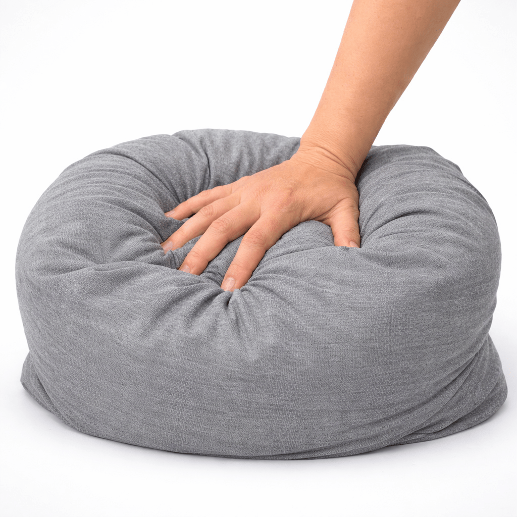 Hand compressing Ultra soft grey bamboo breakup pillow with squishy comfort and low key petty energy