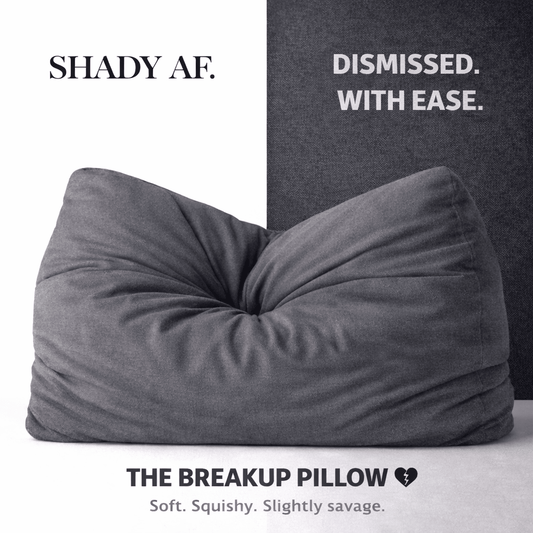 Gray pillow labeled 'The Breakup Pillow' with text on a white and black background.