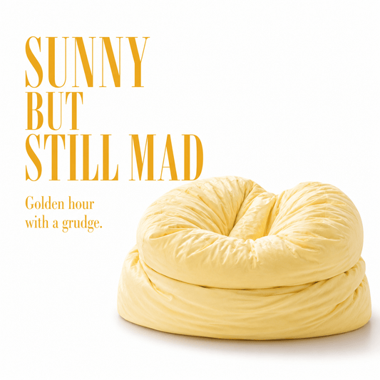 Yellow squishy pillow with text 'Sunny but still mad' on a white background