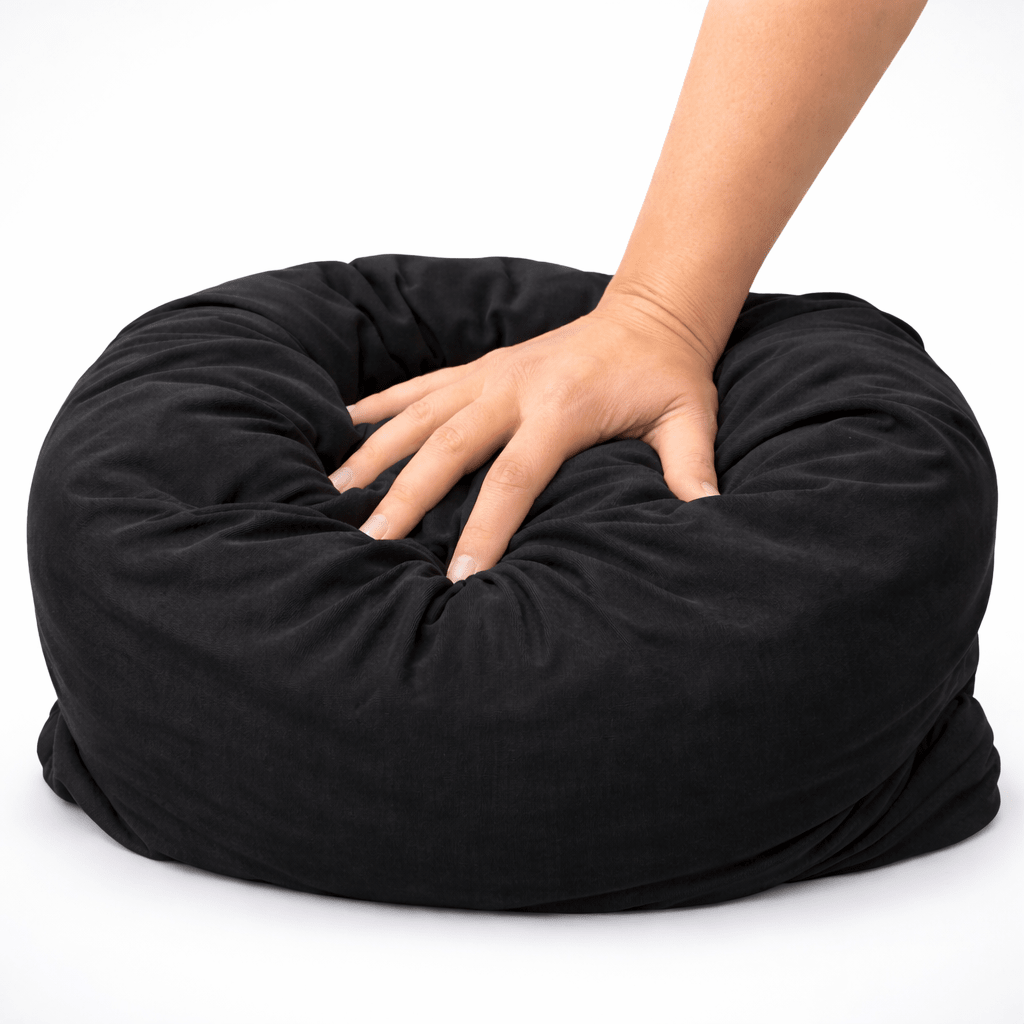 Ultra squishy black pillow compressed to show soft cloud like fill and high density plush support