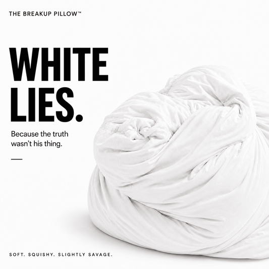 A white crumpled bedding pillow on a clean white background with bold black text reading 'WHITE LIES.' and smaller tagline text.